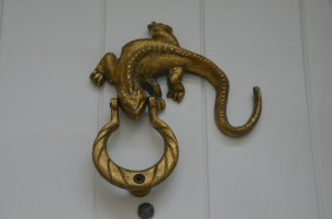 Salamandre en bronze accrochée sur une porte.