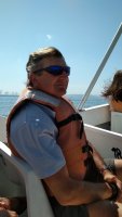 Philippe avec son gilet de sauvetage, assis dans le bateau.